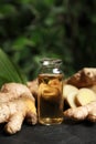 Ginger essential oil in bottle on dark table