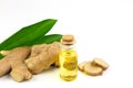 Ginger essential oil in bottle and fresh ginger isolated on white background.