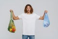 Ginger european man wearing t-shirt posing with bags