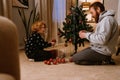 Father and son decorating Christmas tree in living room Royalty Free Stock Photo