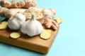 Ginger and fresh garlic on light blue wooden table, space for text. Natural cold remedies Royalty Free Stock Photo