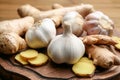 Ginger and fresh garlic on wooden board. Natural cold remedies Royalty Free Stock Photo