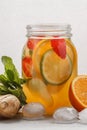 Ginger fruity ice tea with mint in a glass jar, white background Royalty Free Stock Photo