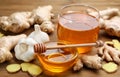 Ginger, garlic and honey on wooden table. Natural cold remedies Royalty Free Stock Photo