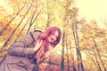 Ginger girl playing in forest. Royalty Free Stock Photo