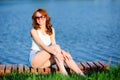 Ginger girl. Portrait of young tender redhead young girl with healthy freckled skin wearing white top looking at camera with Royalty Free Stock Photo