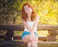 Ginger girl. Portrait of young tender redhead young girl with healthy freckled skin wearing white top looking at camera with Royalty Free Stock Photo