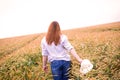 Ginger girl is running in a wheat field Royalty Free Stock Photo