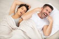 Ginger girl snoring and angry man cannot sleep Royalty Free Stock Photo