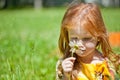 A ginger-haired girl with a flower