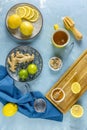 Ginger, honey, lemon and lime herbal tea preparation with high levels of Vitamin C, boosting the immune system. Top view, blue
