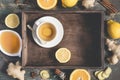 Ginger hot immunity boosting Vitamin natural drink With Lemon, honey and cinnamon On tray and ingredients Royalty Free Stock Photo