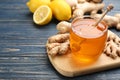 Ginger and jar of honey on blue wooden table, space for text. Natural cold remedies Royalty Free Stock Photo