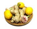 Ginger, lemon and garlic on a wooden tray isolated. Helthy food. Vitamins