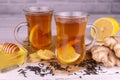 Ginger-lemon tea with honey in transparent cups on a white background. Royalty Free Stock Photo