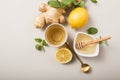 Ginger Lemon Tea with Honey. Warming immune boosting tea with citrus and ginger. Cup, honey,  ginger root on grey  pastel Royalty Free Stock Photo