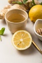 Ginger Lemon Tea with Honey. Warming immune boosting tea with citrus and ginger. Cup, honey,  ginger root on grey  pastel Royalty Free Stock Photo