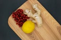 Ginger, lemon and viburnum on a wooden background. Healthy Eating. Natural remedies for colds and flu. Royalty Free Stock Photo
