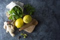 Ginger, lemons and mint leaves on dark background. Ginger tea, drink ingredients, cold and autumn time. Copy space