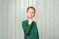 Ginger little boy 7-9 years old looking sideways with doubtful and skeptical expression Royalty Free Stock Photo