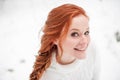 Ginger nice female in white sweater in winter forest. Snow december in park. Portrait. Christmas cute time. Royalty Free Stock Photo