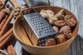 Ginger with nutmeg and grater in bowl on wood Royalty Free Stock Photo
