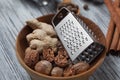 Ginger with nutmeg and grater in bowl on wood Royalty Free Stock Photo