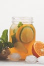 Ginger orange ice tea with mint in a glass jar, white background Royalty Free Stock Photo