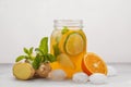 Ginger orange ice tea with mint in a glass jar, white background Royalty Free Stock Photo