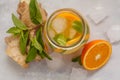 Ginger orange ice tea with mint in a glass jar, white background Royalty Free Stock Photo