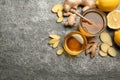 Ginger and other natural cold remedies on grey table, flat lay. Space for text Royalty Free Stock Photo