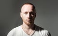 Ginger red bearded unshaven brutal man isolated at dark gray background studio photo. Handsome ginger man with beautiful