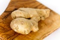 Ginger root, isolated on the wooden background Royalty Free Stock Photo