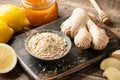 Ginger root, ginger powder, honey and fresh  lemons on wooden table Royalty Free Stock Photo