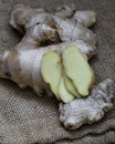 Ginger root sliced on wooden table Royalty Free Stock Photo