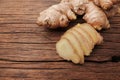 Ginger root sliced on wooden table Royalty Free Stock Photo