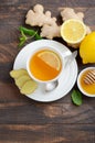 Ginger root tea with lemon and honey on wooden background. Royalty Free Stock Photo