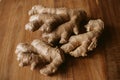 Ginger root on wooden background close up view.