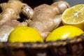 Ginger roots and lemon on wooden basket close up Royalty Free Stock Photo