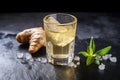 ginger shot in a stone shot glass on a granite surface