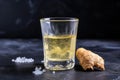 ginger shot in a stone shot glass on a granite surface