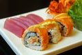 Ginger sushi rolls with delicacy and decoration served on a white tray