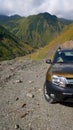 Ginger SUV parked on edge of road in georgian mountains Royalty Free Stock Photo