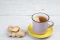 Ginger tea in a cup on wooden background