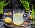 Ginger tea with lemon in a glass mug on a dark concrete background Royalty Free Stock Photo