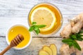 Ginger tea with lemon mint and honey on a white wooden background. Hot healthy winter drink Royalty Free Stock Photo