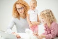 Ginger teacher giving lessons for little children Royalty Free Stock Photo