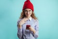 Ginger teenager wearing red cap and blue shirt looking at the camera