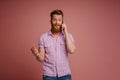 Ginger white man expressing surprise and talking on mobile phone Royalty Free Stock Photo