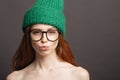 Ginger woman wearing glasses and green hat pouting her lips ready for kiss Royalty Free Stock Photo